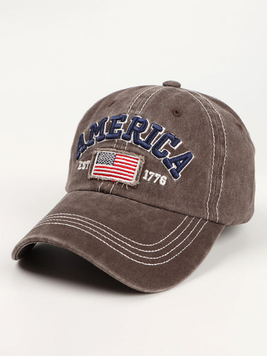 Adjustable brown denim hat styled with patriotic American flag embroidery.