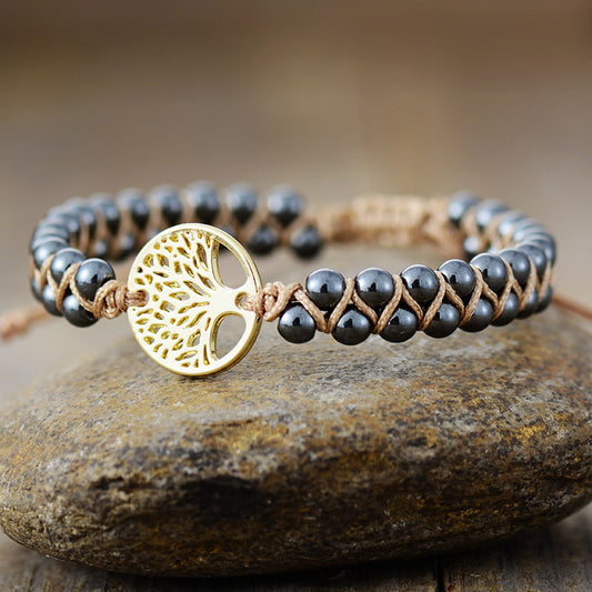 Adjustable gold bracelet with braided and stone accents