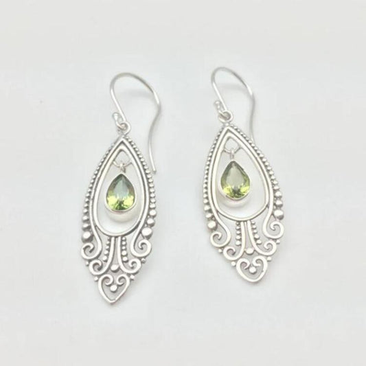 Alloy earrings with intricate cutout design and rhinestones