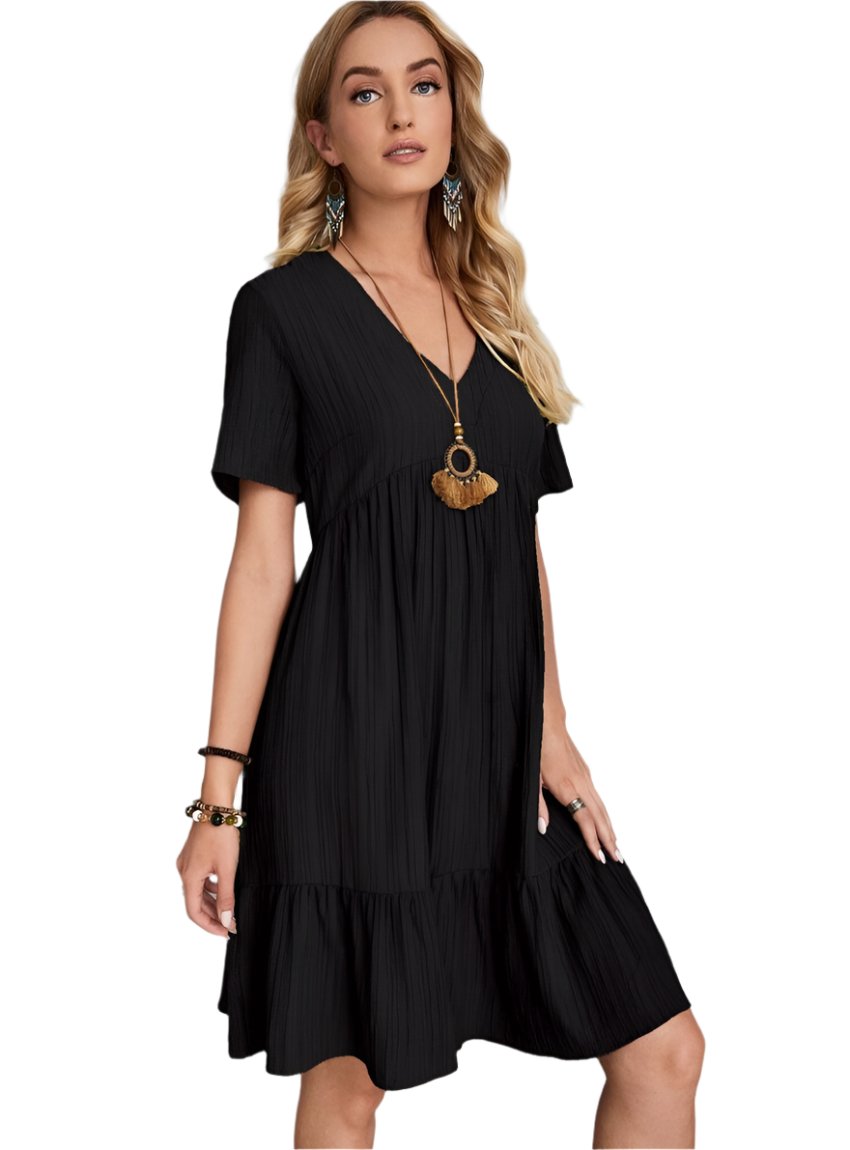 Effortless black babydoll dress with V-neckline and tiered hem
