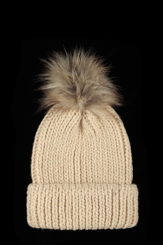 Beige winter knit beanie with faux fur pom for added style.