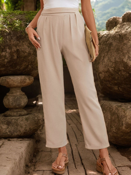 Tapered leg design on beige ruched waist pants, ideal for work or casual wear.