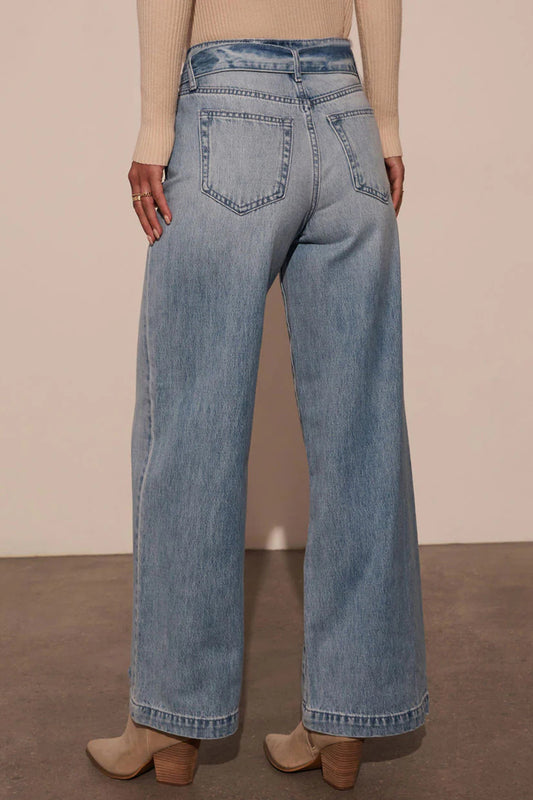 Back view of light wash high-waist wide-leg jeans featuring a relaxed wide-leg design.