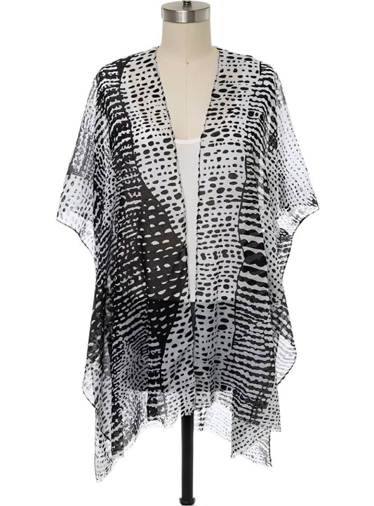 Front view of a black and white dots kimono cardigan with an open front.