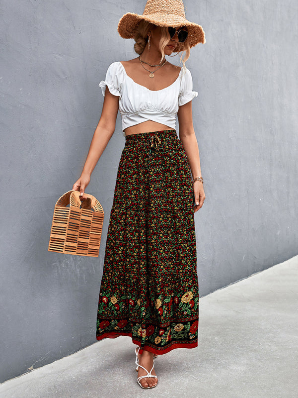Black boho long skirt featuring a bold floral pattern and a flowy silhouette.