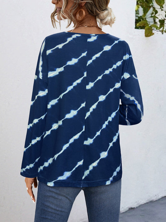 Women’s long sleeve henley shirt with tie-dye print, offering a relaxed, casual fit.