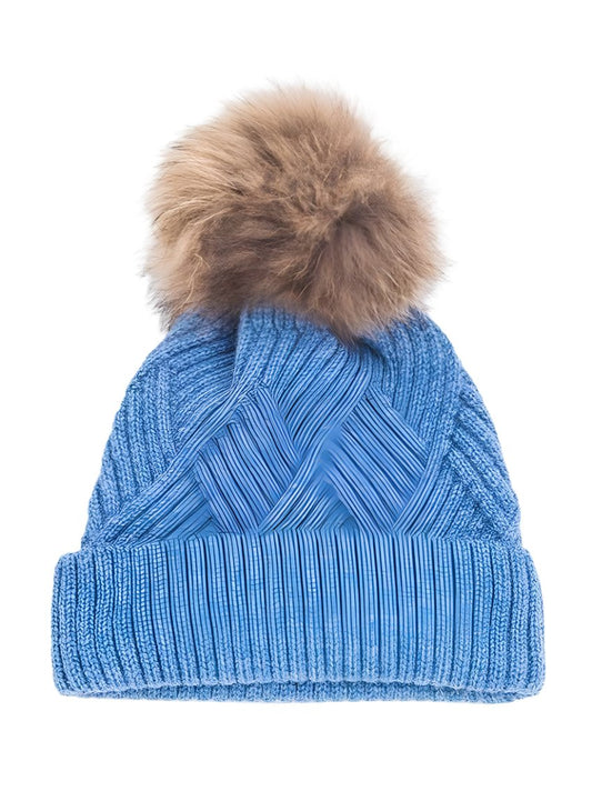 Blue cable knit beanie featuring a cozy faux fur pom
