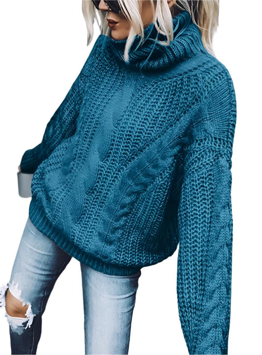 Front view of blue cable knit turtleneck sweater showcasing oversized fit and elegant knit details