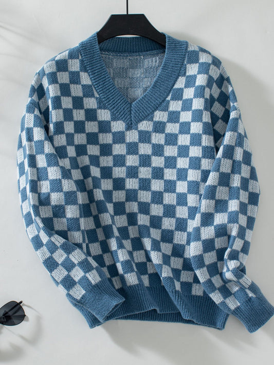 Trendy blue sweater featuring a checkerboard pattern and V-neckline.
