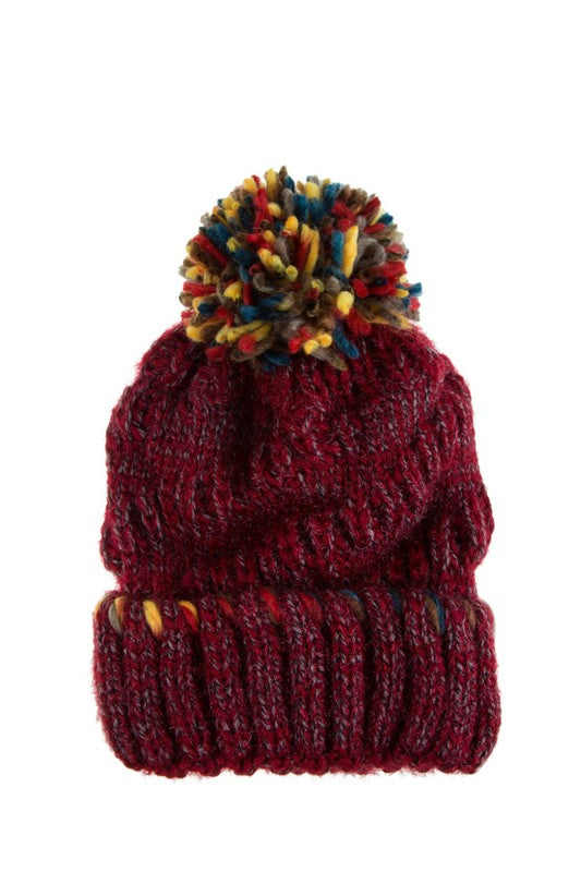Winter beanie in burgundy with multi-color accents and a bold pom-pom.