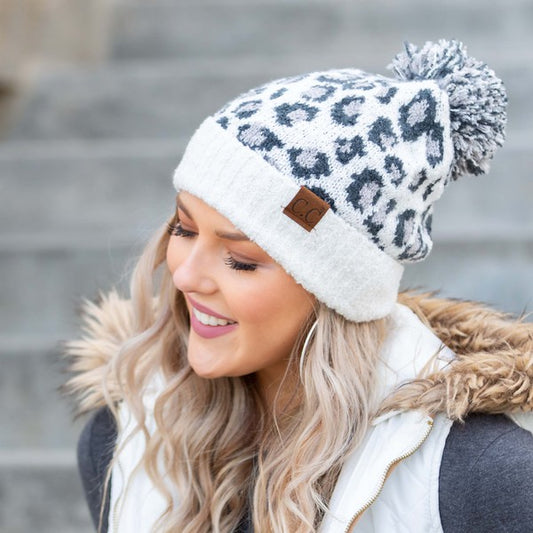 Ivory leopard print winter hat with pom, perfect for cozy outings