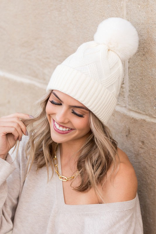 White chunky knit beanie with a soft stretchy fit and faux fur pom
