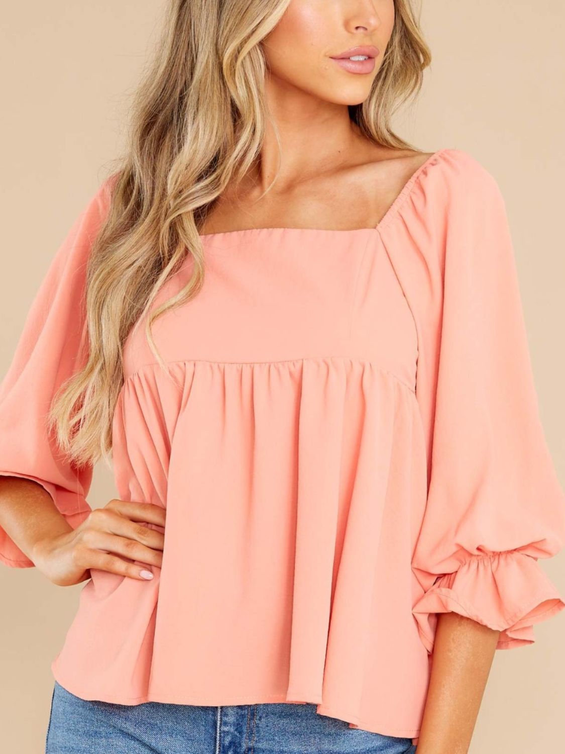 Coral flowy babydoll blouse, ideal for casual or semi-dressy outfits.