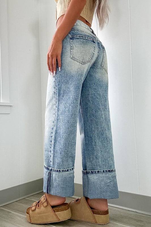 Back view of cuffed light wash wide leg jeans featuring a structured design.
