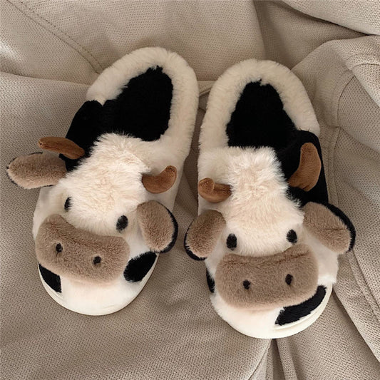 Cute cow plush slippers with a 3D cow face, horns, and ears for indoor comfort