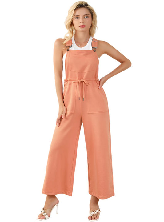 Front view of Drawstring Overalls with Pockets styled with a white tank and heels.
