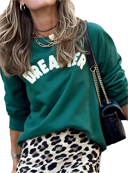 front view of green "Dreamer" graphic sweatshirt with slightly stretchy fabric