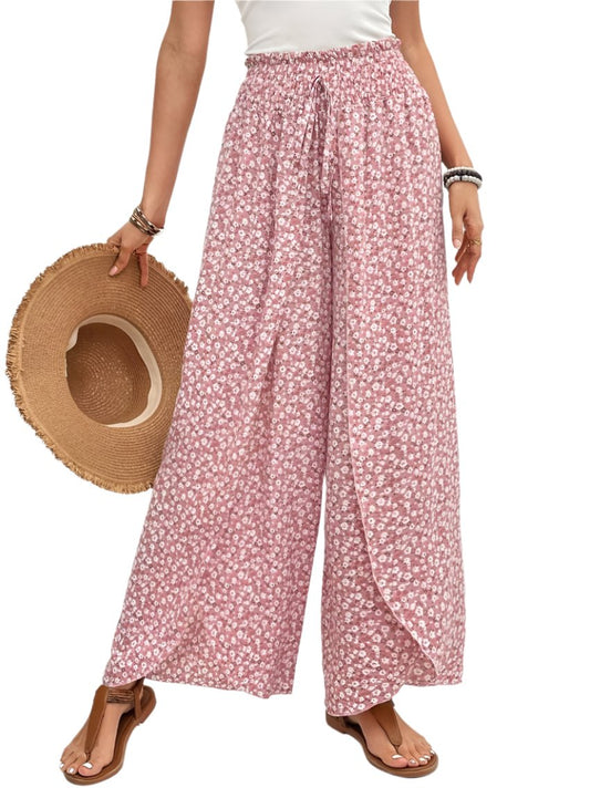 Front view of blush pink floral wide-leg pants with side slits and drawstring waist