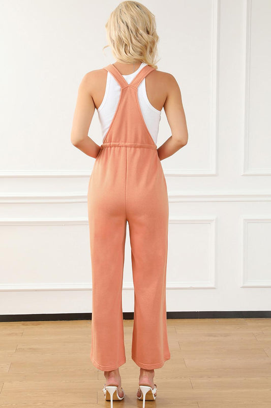 Peach-colored drawstring waist overalls paired with heels for an elevated casual look.