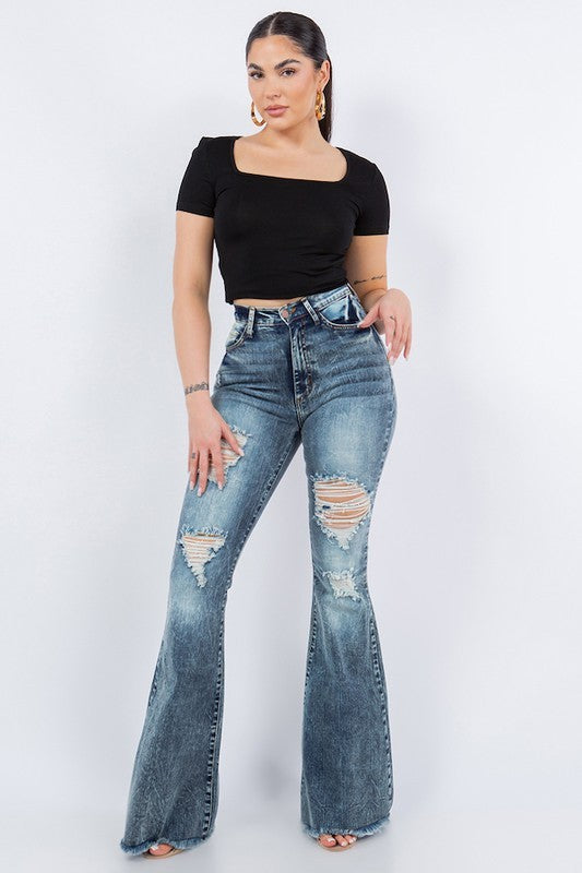 Full-length ripped bell bottom jeans for women, high-waist fit.