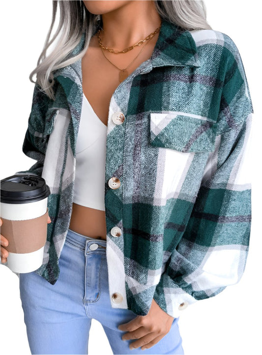 Close-up of green plaid button-up long sleeve jacket, styled casually.