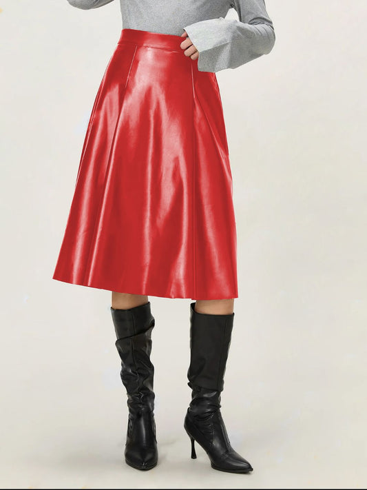 Model wearing black A-line leather skirt paired with knee-high boots.