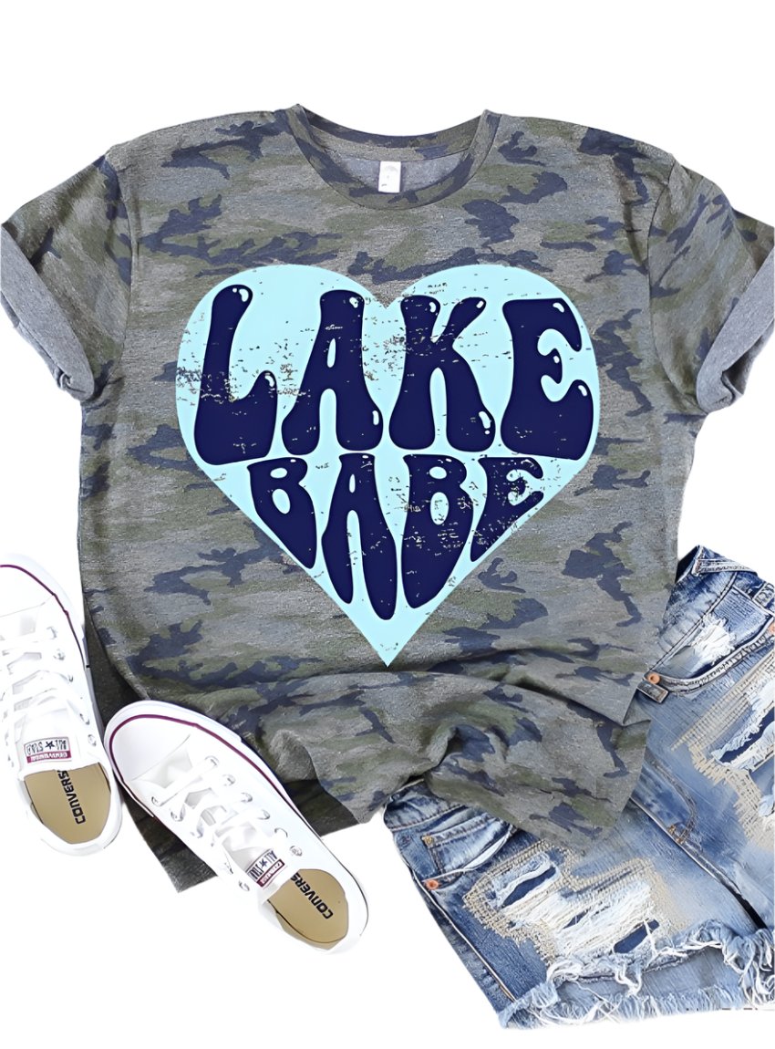 Front view of Lake Babe Heart Graphic Tee on vintage camo fabric.