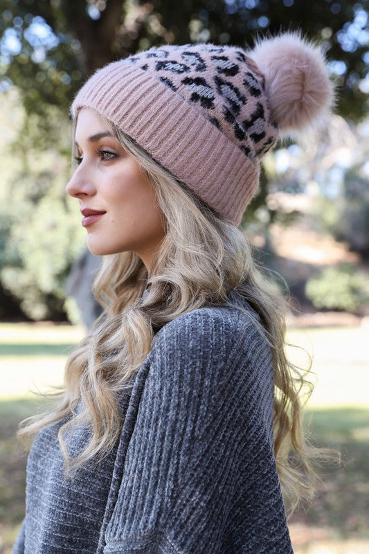 Pink and white leopard print knit beanie with matching faux fur pom