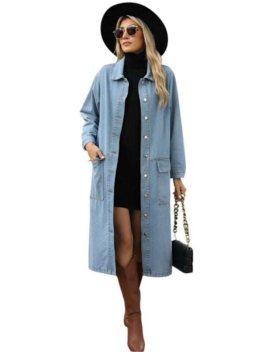 Woman wearing a long denim button-up jacket with pockets and a relaxed fit.