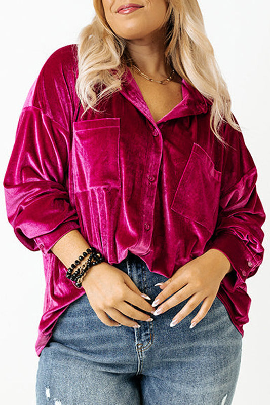 Plus-size model showcasing a magenta velvet shirt with a drop shoulder design.