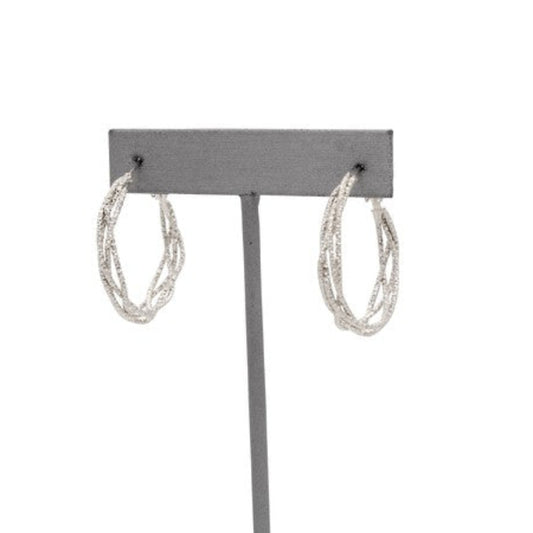 Front view of multi-layered intertwined hoop earrings with a textured silver-tone design.