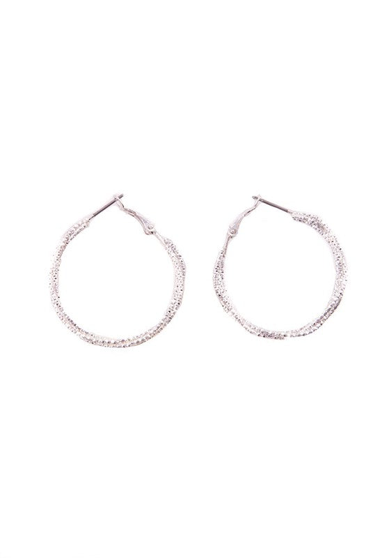 Silver-tone multi-layered hoop earrings with a modern intertwining design.