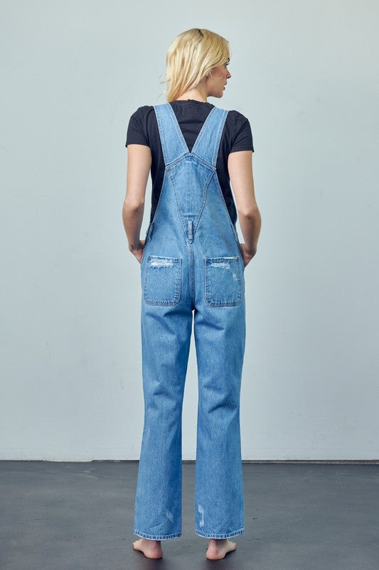 Casual medium wash denim overalls with distressed knee details and high waist.