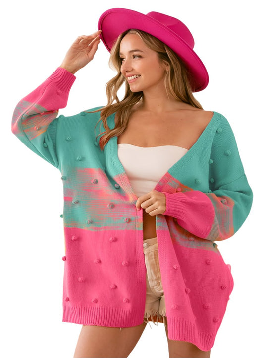 Pink and teal cardigan with fun pompom accents and open front
