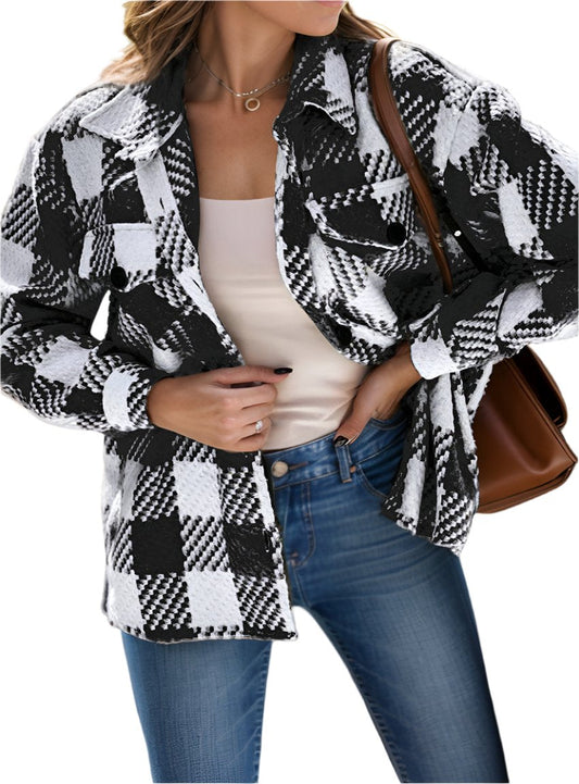 Woman wearing a black-and-white plaid button-up long sleeve shacket.
