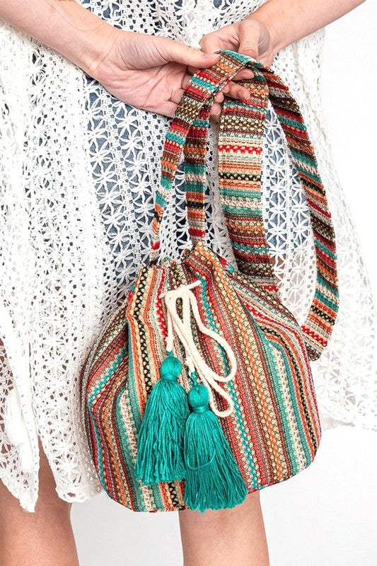 Spacious boho bucket bag with vibrant woven details and drawstring closure.