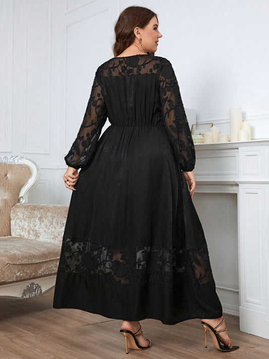 Back view of a plus-size black lace dress with a flowing silhouette.