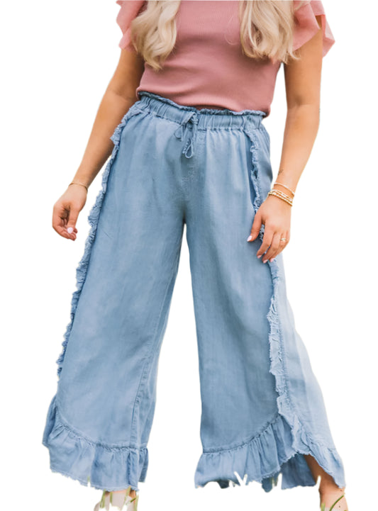 Front view of raw hem ruffled wide-leg pants in light wash showing flowy, feminine design.