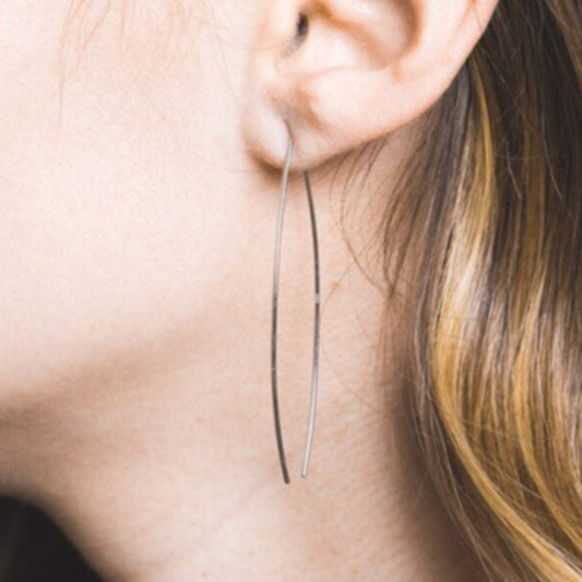 Model wearing Silver Arc Threader Earrings, showing lightweight and elegant design.