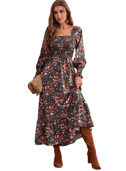 Front view of smocked floral square neck dress with tiered skirt and long sleeves.