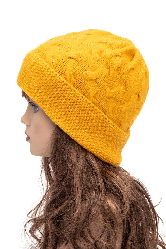 Comfortable mustard beanie featuring intricate cable pattern