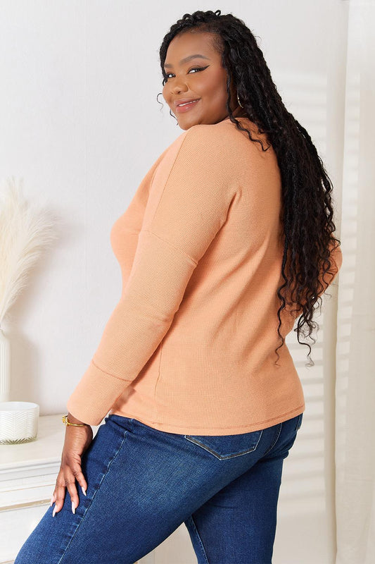 Soft and chic peach button-front long-sleeve top for daily wear.