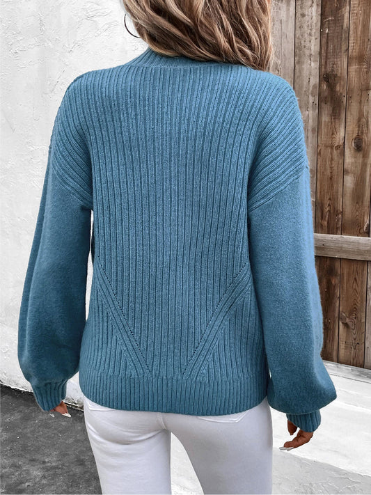 Soft blue cardigan with ribbed texture, featuring a convenient zip closure.