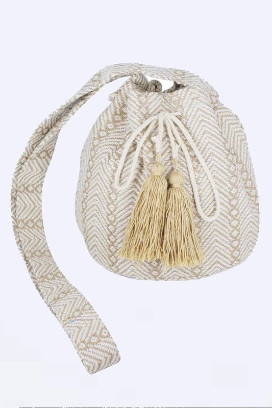 Taupe Aztec-inspired boho bucket bag with spacious interior.