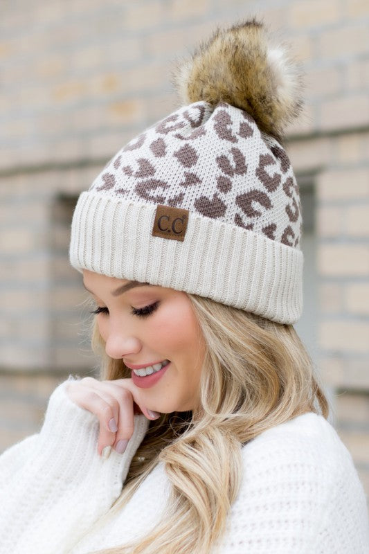 Brown CC leopard print pom hat, combining cozy warmth with bold style