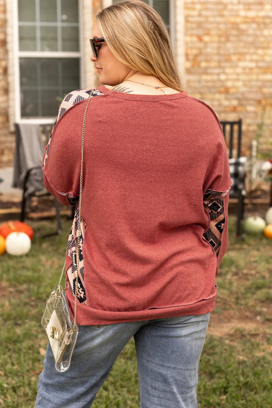 Trendy geometric print plus-size sweatshirt styled for casual fall wear.
