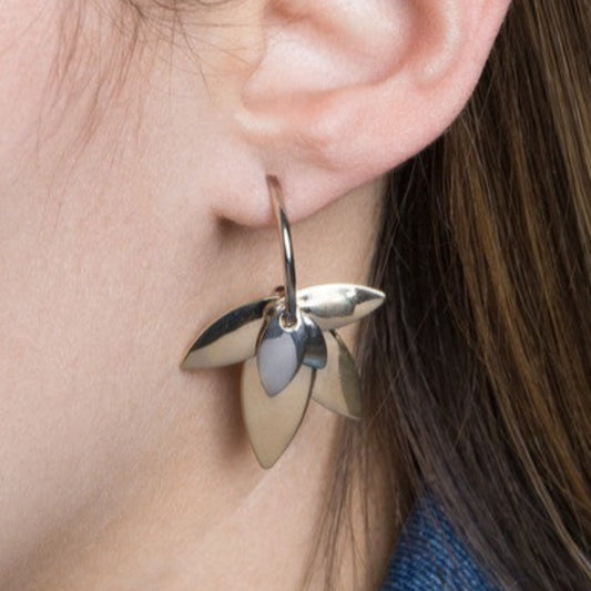 Front view of two-tone lotus hoop earrings featuring a polished silver and gold lotus leaf design.