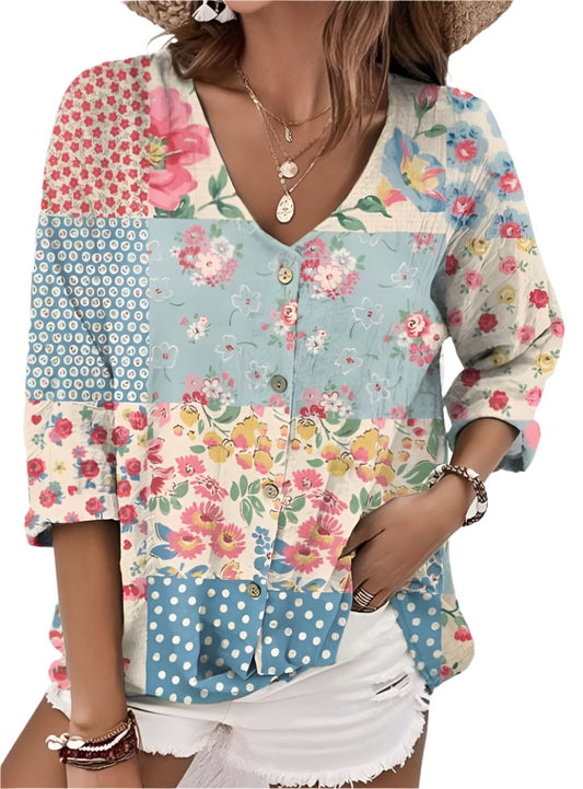 Woman wearing a patchwork floral blouse with polka dots and a V-neckline.
