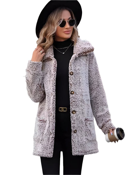 Woman wearing a plush button-up pocketed jacket in light brown.