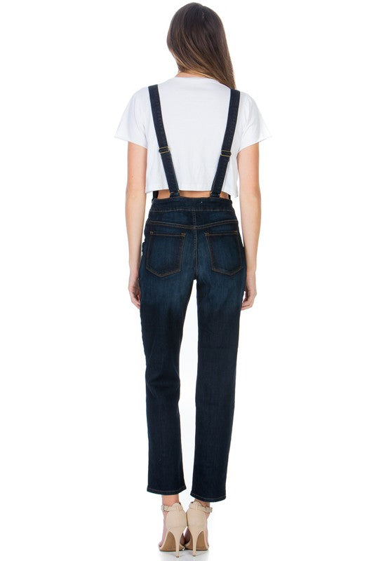 Back view of dark wash denim overalls with two back pockets.